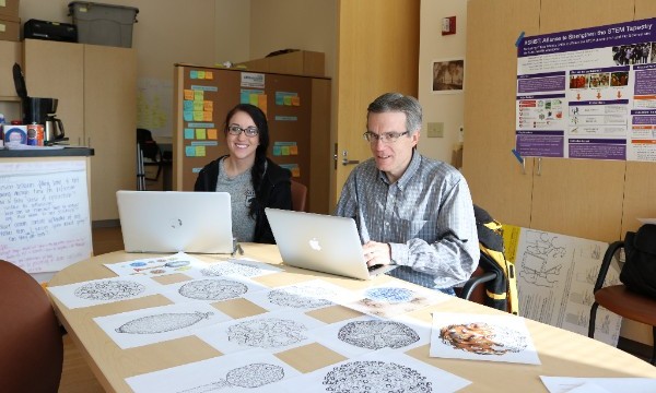 Ambassador David Belnap and artist Samantha Dewey working on virus coloring pages.