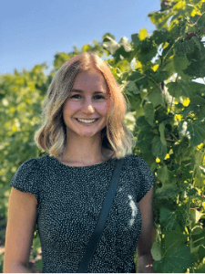 emily carroll standing in front of greenery