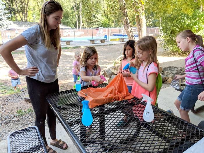 Ambassador Kendall FitzGerald helps campers build their own mini watersheds.