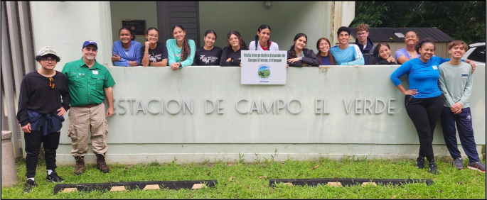 John Bithorn Torrens and students gather around the El Verde Field Station sign