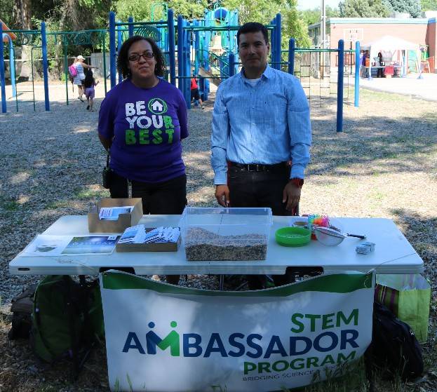 Ambassador Daniel Mendoza talks to a teacher from Neighborhood House about air quality monitoring.