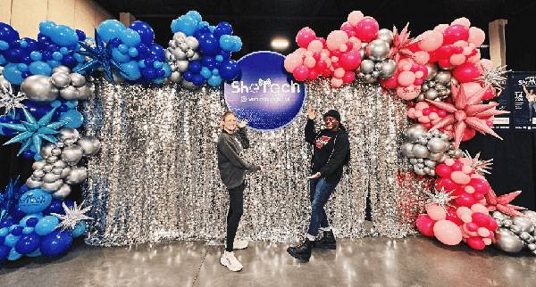 madison parrot and annabel anyang showing off shetech sign