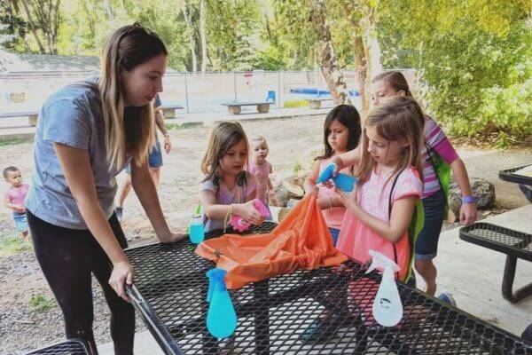 Ambassador Kendall FitzGerald helps campers build their own mini watersheds.