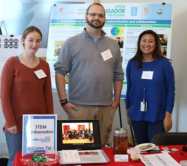 Group of ambassadors at a convention standing behind a table